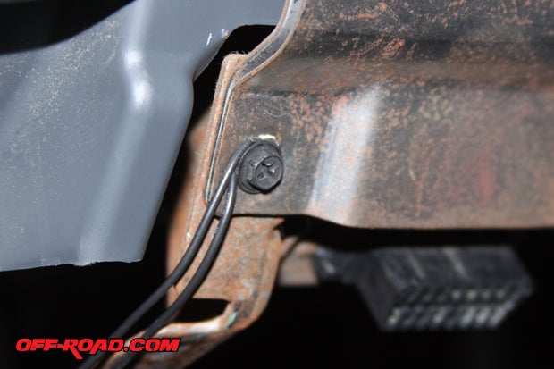 On the drivers side, at the bottom of the dash, is an existing bolt attached to structural metal. Use this bolt for your ground.